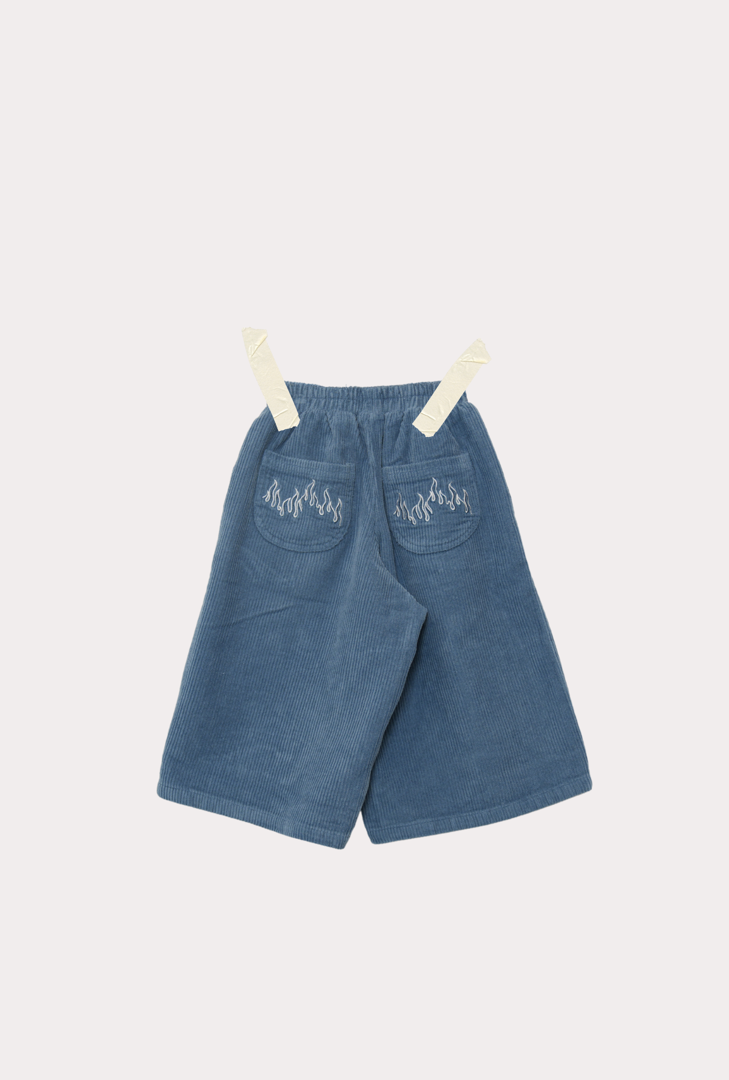 back of wide-leg Blaze Cord Pant in blue flame colourway with pocket flame embroidery motif — 100% cotton