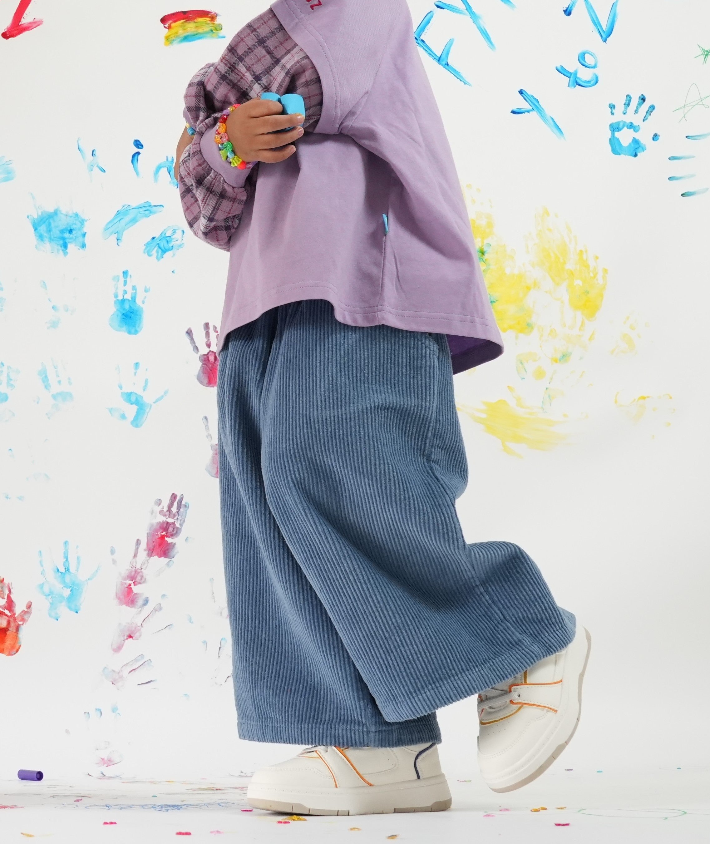 Child wearing Blaze blue cord pants with elastic waistband and Ollie double-sleeve in purple fig — From Y To Z