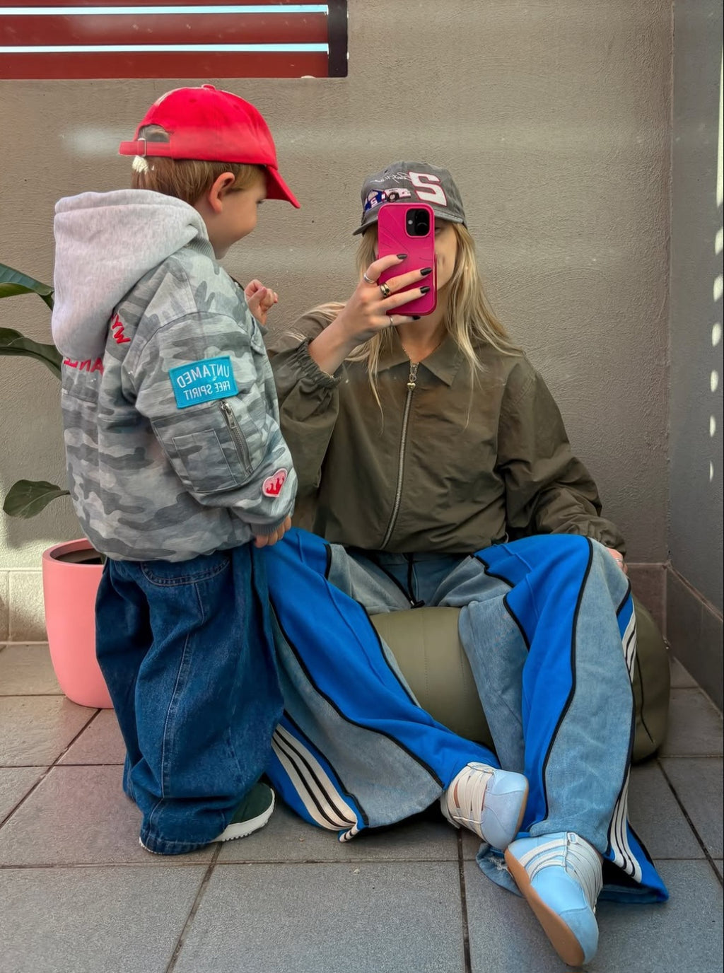 Ash Sambell with son Mickey taking a mirror selfie wearing the ruhi denim jean