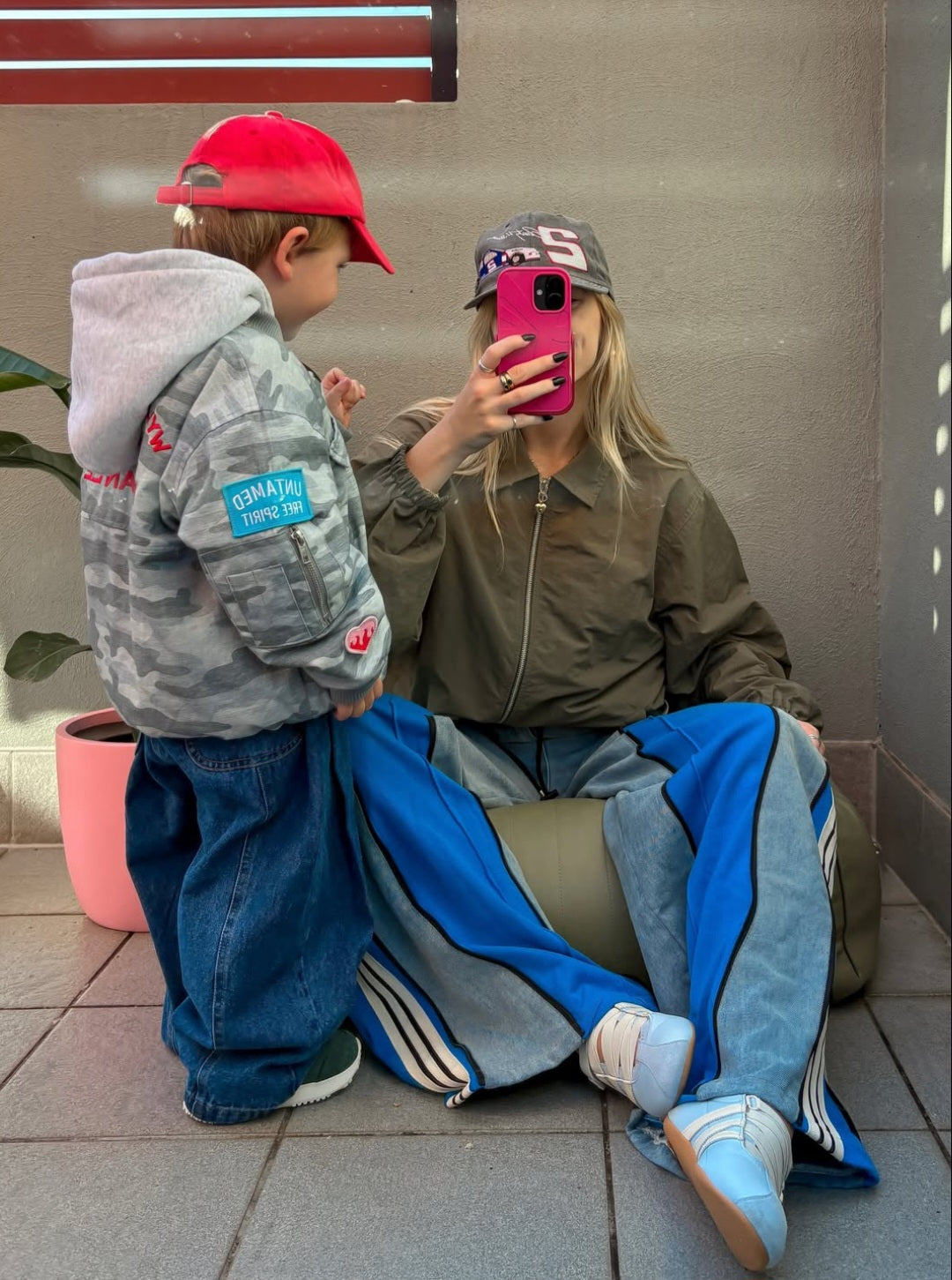 Ash Sambell with son Mickey taking a mirror selfie wearing the ruhi denim jean