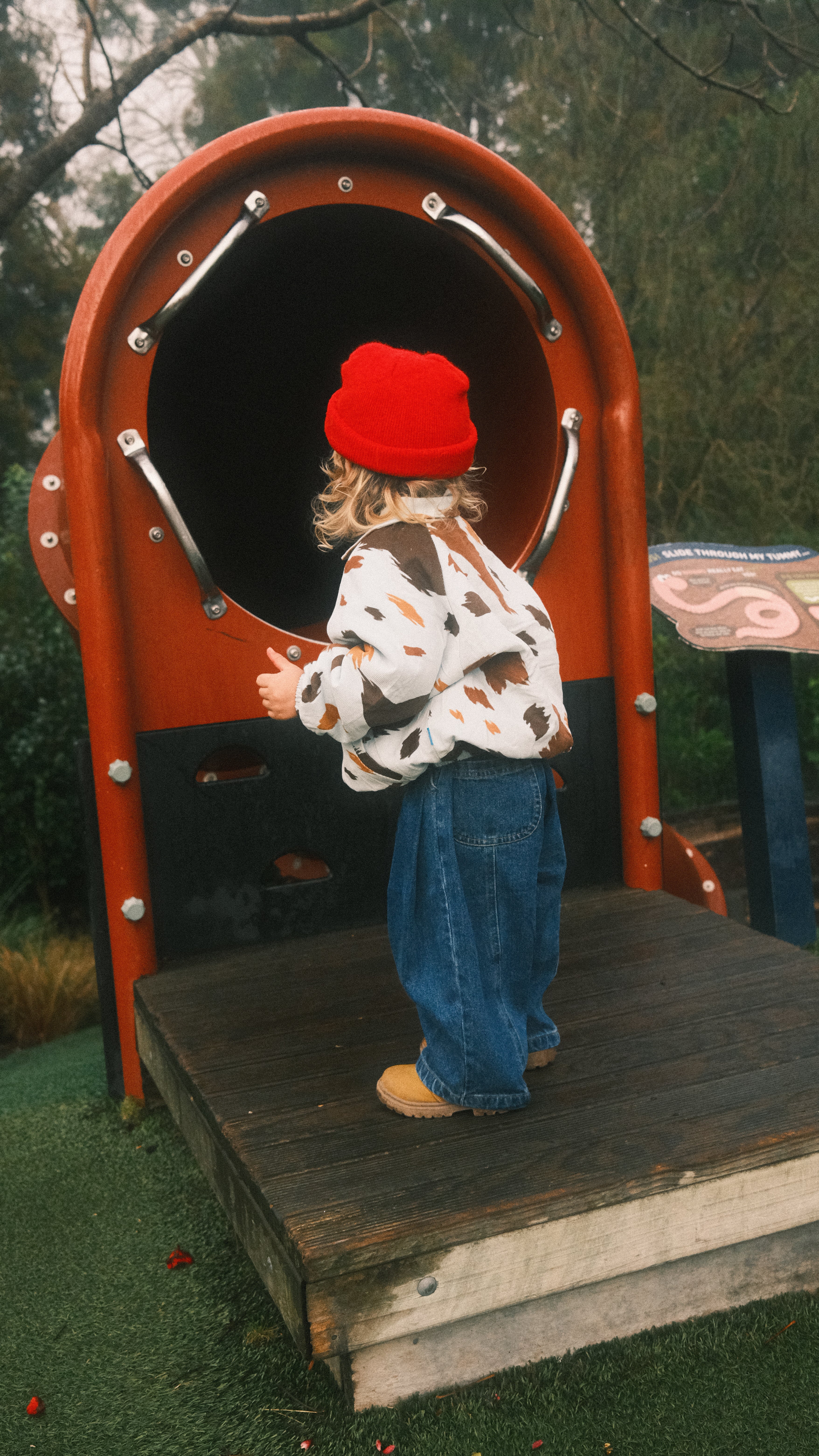 Child near slide wearing seffi jacket milkyway and ruhi jean