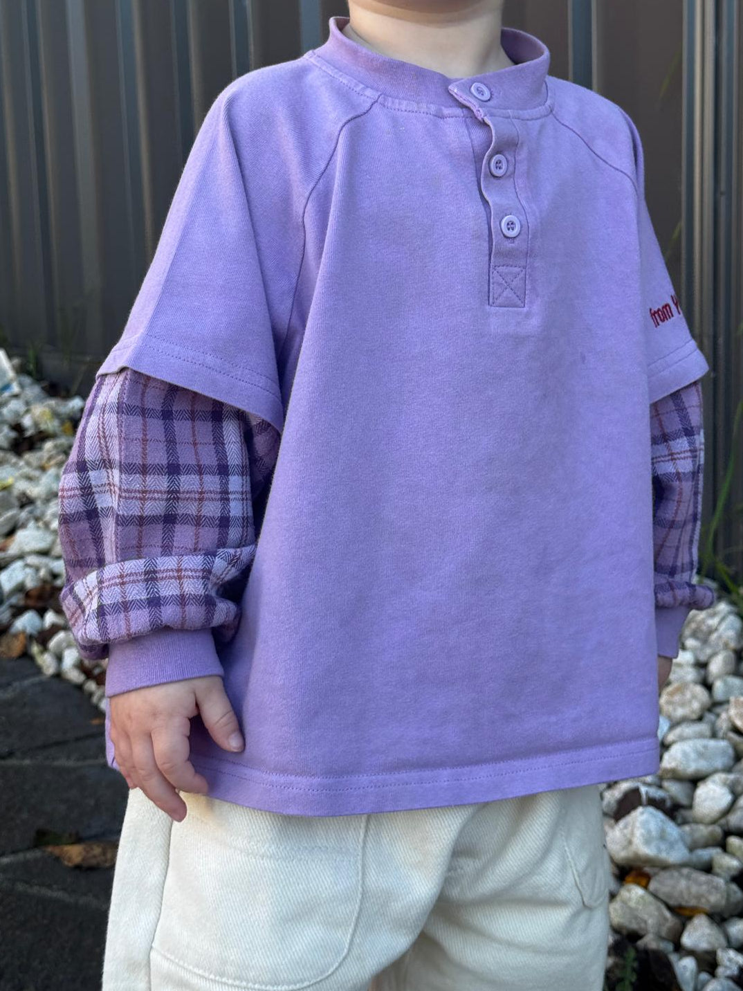 Toddler wearing purple plaid long sleeve ollie